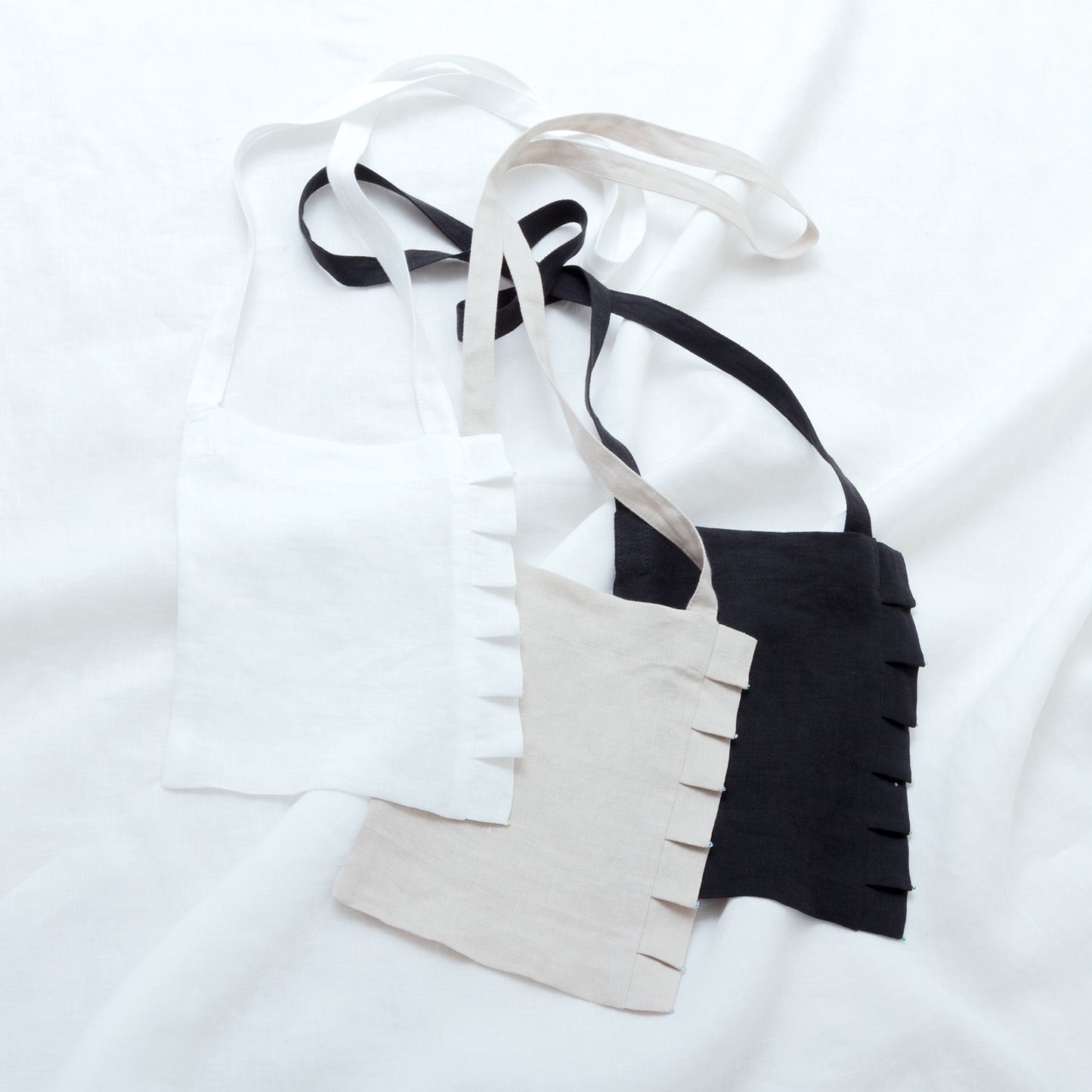 Linen pochette with tuck frills and beads
