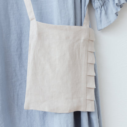 Linen pochette with tuck frills and beads